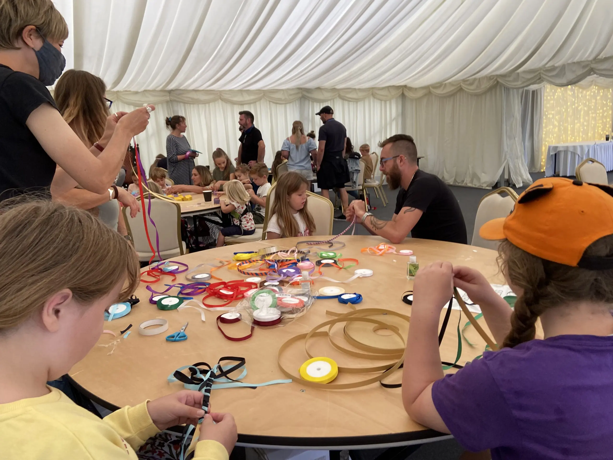 people sitting around a table doing crafts