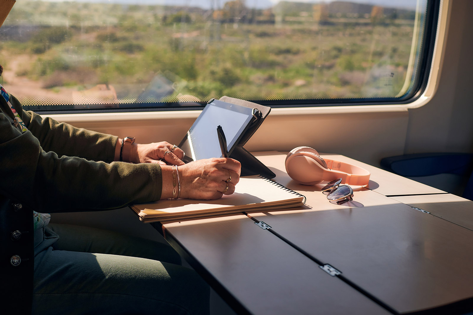 Man at desk on train - Invest at Otterpool Park