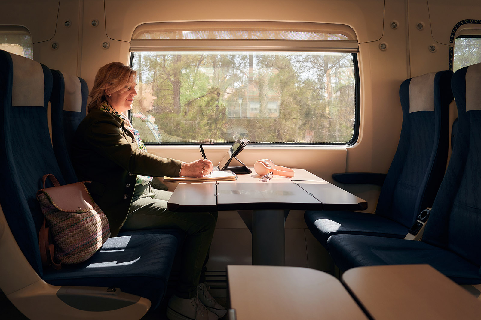 woman at desk on train - Locate your business to Otterpool Park