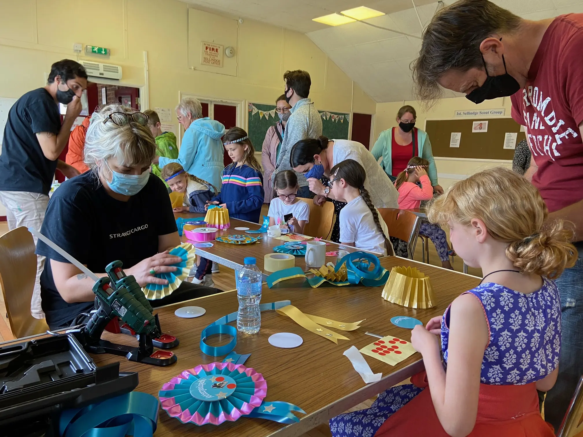 people doing crafts around a table